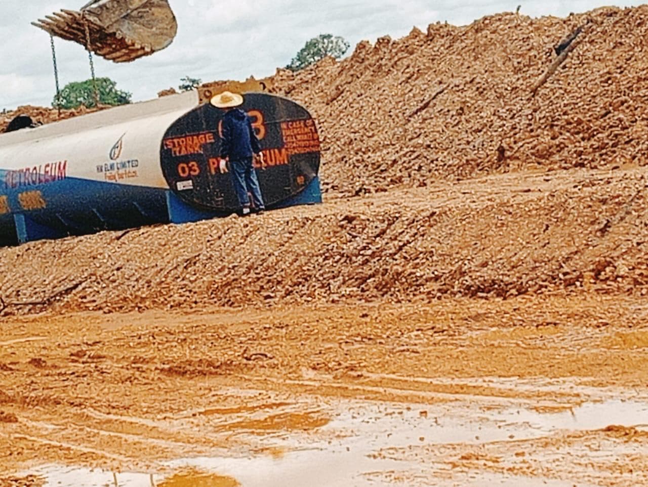 Team supervising tank installation